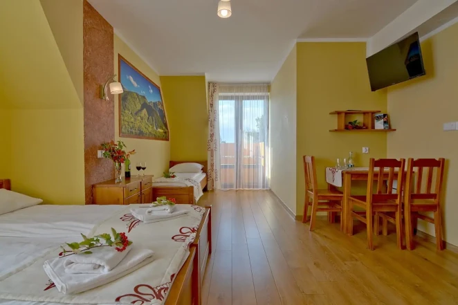 Comfort/Balcony room for four guests with a private bathroom and mountain views